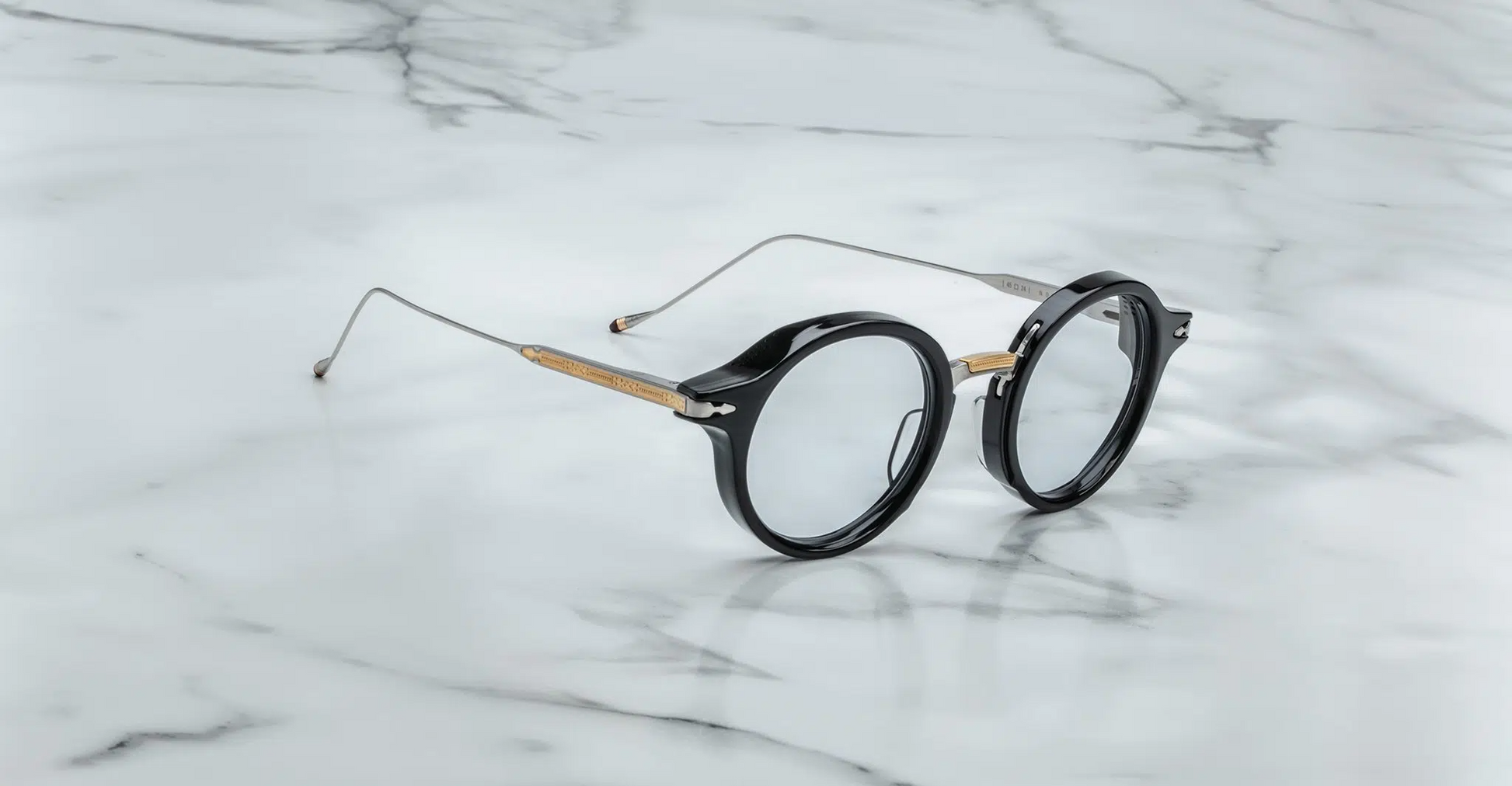 Three-quarter angle of Jacques Marie Mage Norman in noir, showing the contrast between thick acetate front and precision metal detailing