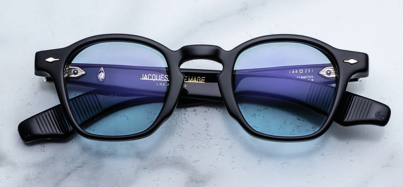 Jacques Marie Mage Zephirin Obscure sunglasses front view featuring a handcrafted black acetate frame, iconic round silhouette and serene blue CR39 lenses