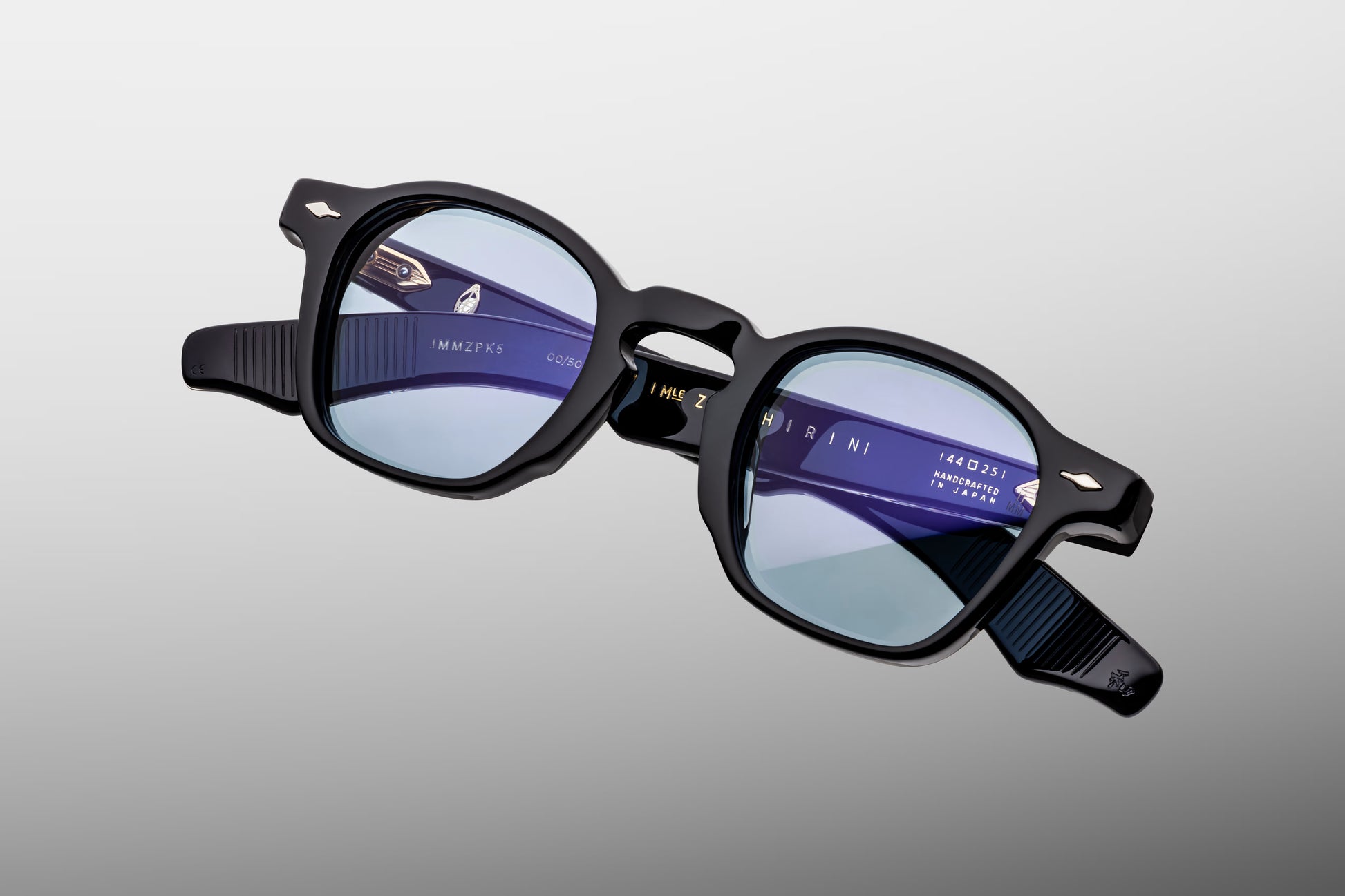 Close-up front view of Jacques Marie Mage Zephirin Obscure sunglasses featuring the iconic P3-inspired lens shape, polished black acetate and serene blue lenses
