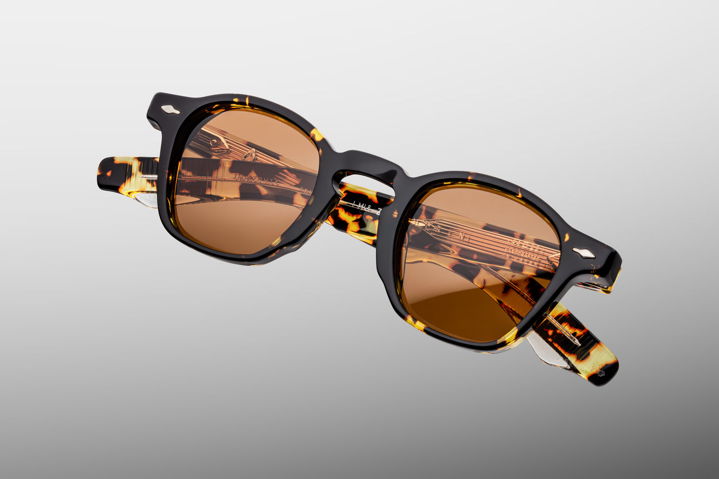 Close-up front view of Jacques Marie Mage Zephirin Tokyo sunglasses featuring the signature pre-war-inspired frame shape, polished Havana acetate and orange CR39 lenses