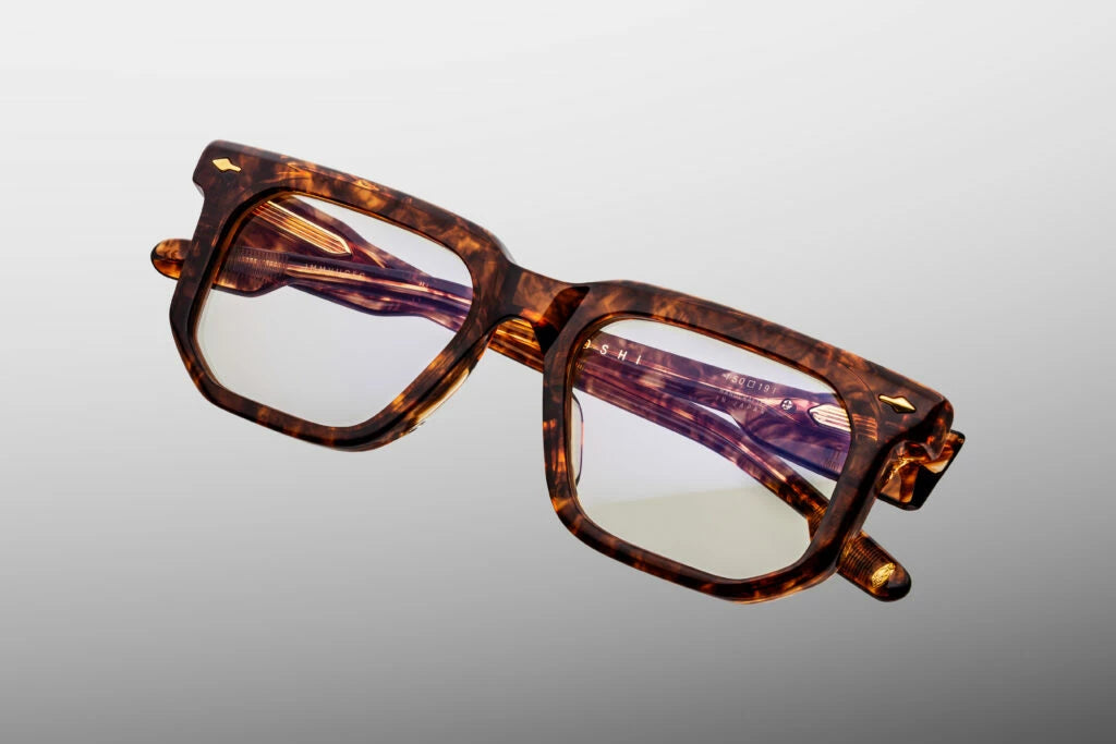 Top-down view of the Jacques Marie Mage Argyle eyeglasses, emphasizing the substantial thickness of the front block acetate profile. From above, the clear beige inner laminates of the bold temples showcase the full parallel alignment of the exposed internal dark gold wire cores and heavy-duty hinges. Available at WINK Optometrists.
