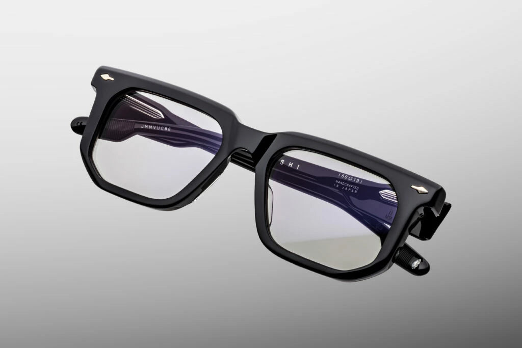 Top-down view of the Jacques Marie Mage Yoshi Black RX eyeglasses, emphasizing the substantial thickness of the front block acetate profile. From above, the sleek alignment of the bold, geometric temples is visible, showcasing the internal silver wire cores and the robust, heavy-duty hinge construction. Available at WINK Optometrists.
