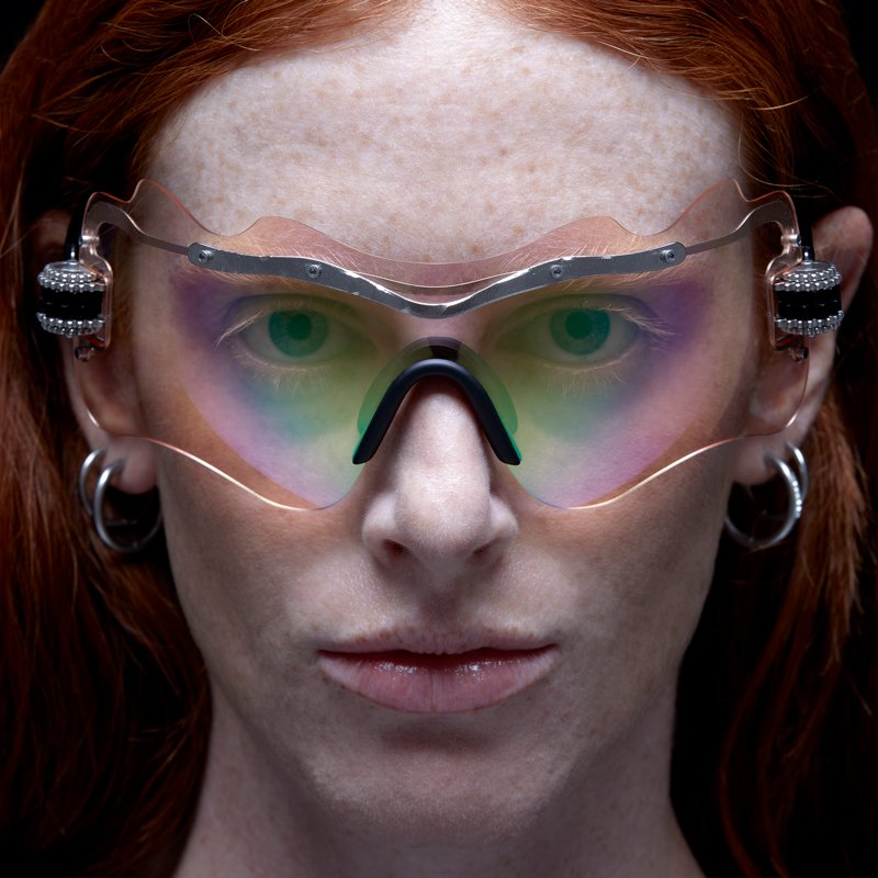 Model wearing Kuboraum E16 SI Silver sunglasses — large shield-style rimless lenses covering eyes and brow for a bold, fashion-forward look