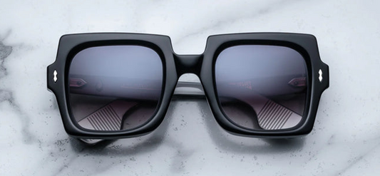 Front view of Jacques Marie Mage Velvet Underground Squeeze sunglasses in Noir, featuring bold rectangular black acetate frames and dark lenses