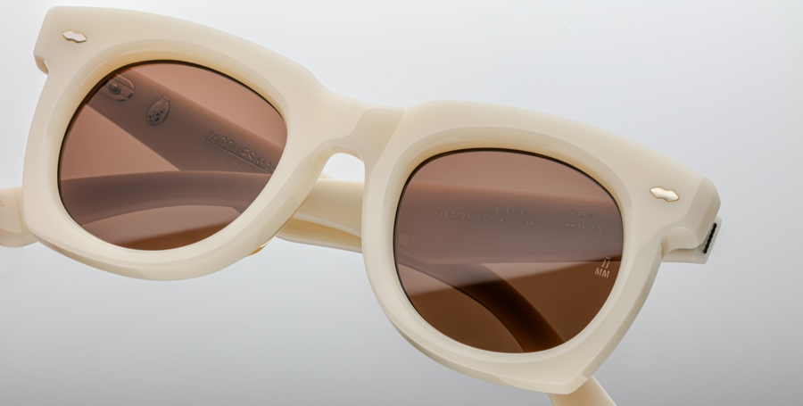 The ‘Ava’ is a sleek '50s inspired glasses with graceful lines, signature double-arrowhead front pins, and custom double-laminated temples with refined 'Lever' wire core. White 8mm cured cellulose acetate frame with custom double laminated acetate temples featuring precious metal hardware and primary brown lenses. Limited edition of 150 pieces. Handcrafted in Japan. Size 45/24. 