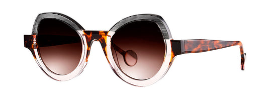 Theo Modernisme eyewear featuring a unique design with a pink, black, and brown color scheme, showcasing a bold and contemporary style.